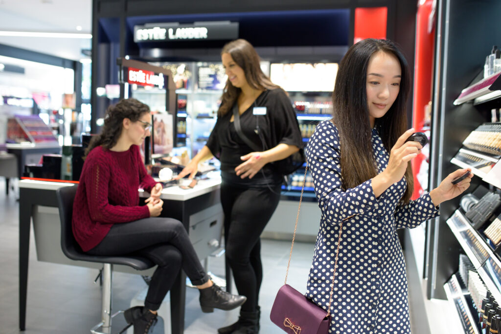 Woman shopping for makeup in Shoppers Drug Mart.